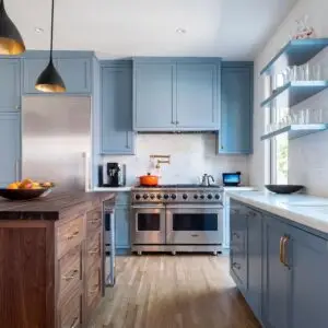 Blue kitchen cabinets with white countertop. Viking Stove.