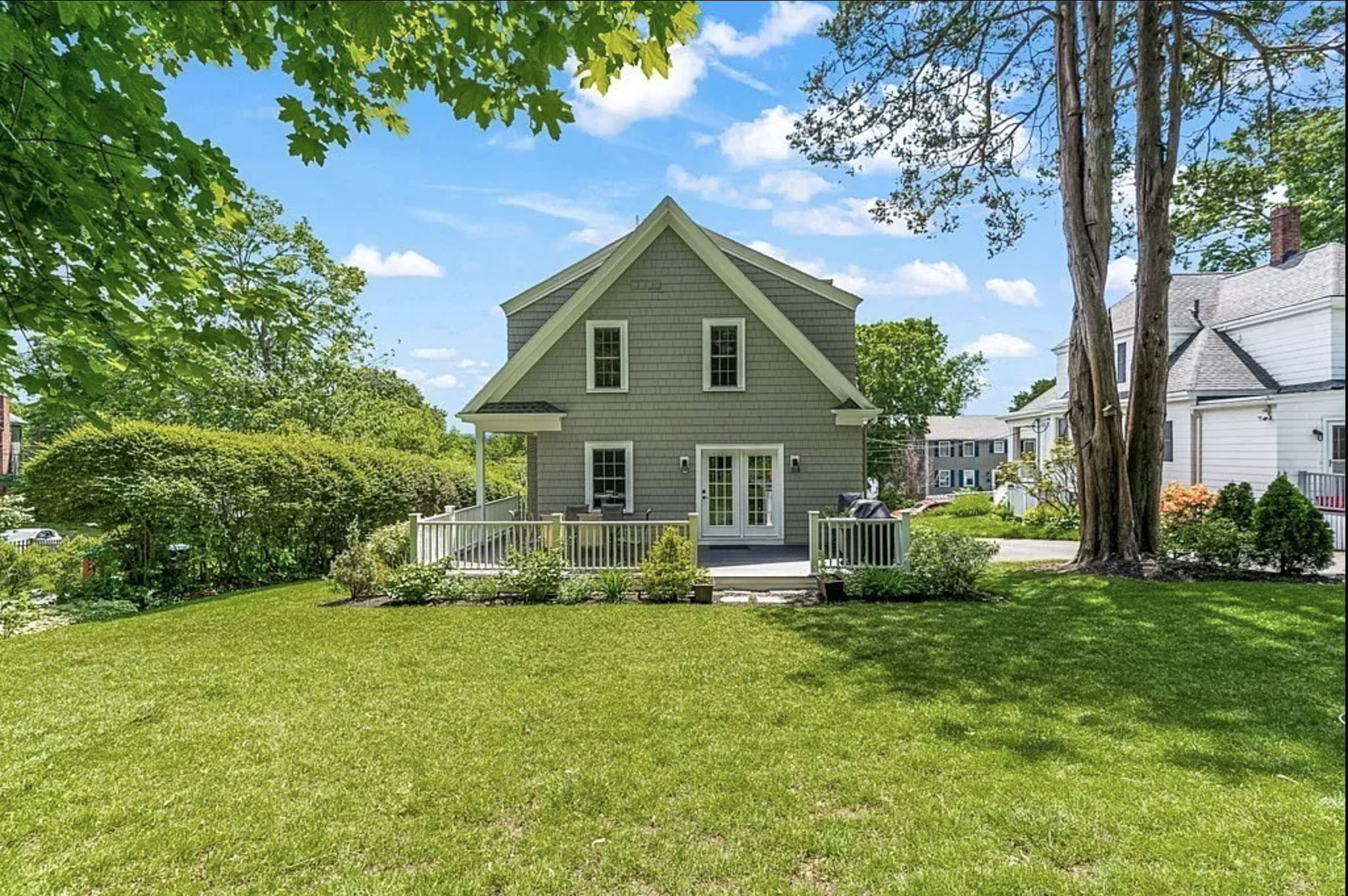 Melrose Addition to oversized cape. Rear addition with master suite and family room. Ceder shingles green.