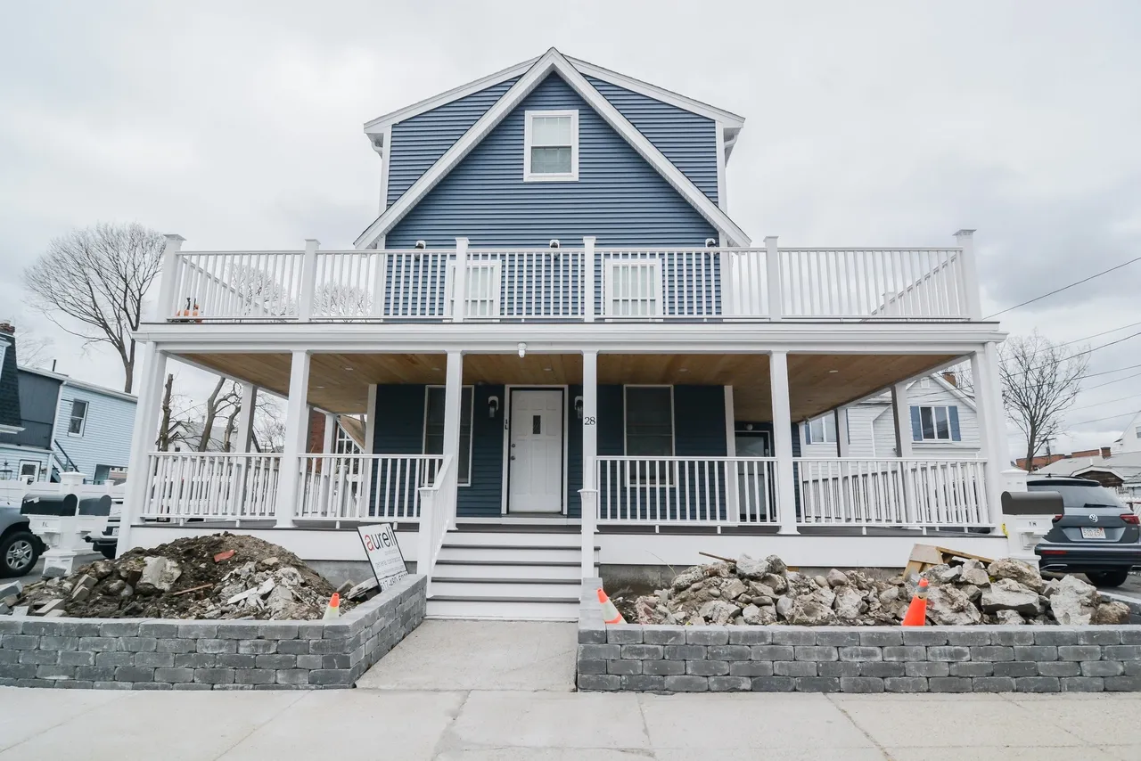 Winthrop home with wrap around porch. Home is blue with white trim.