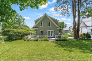 Melrose MA addition with cedar shingles painted green