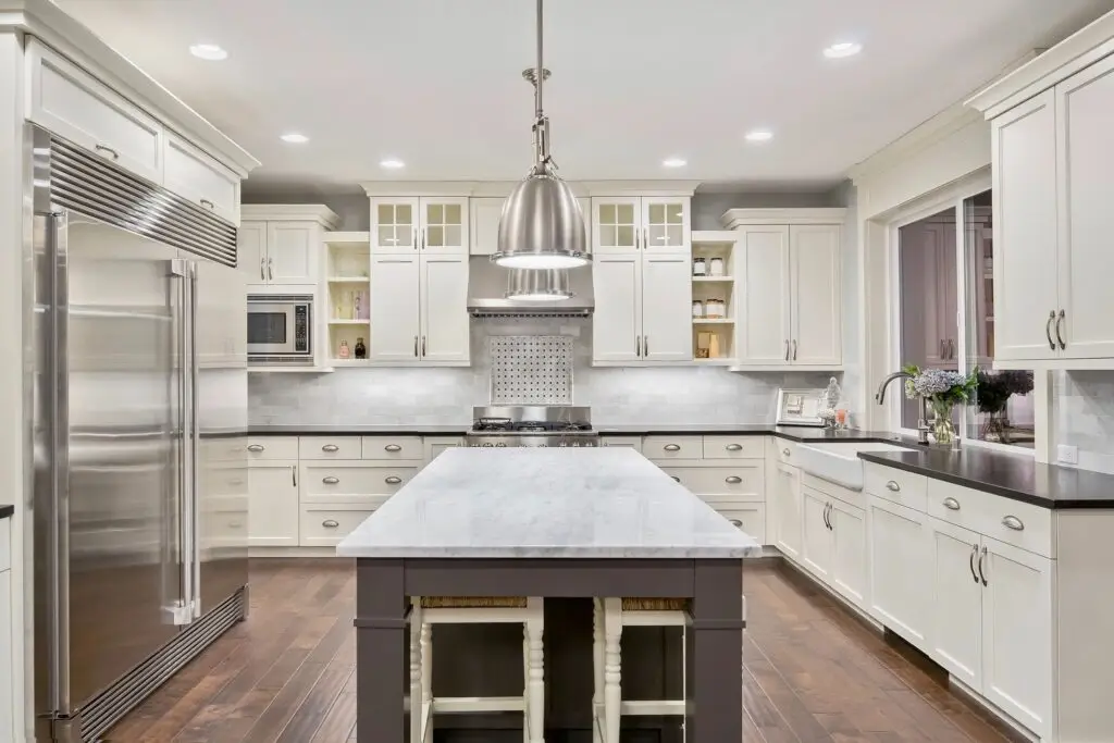 White Gourmet Kitchen with gold accents and high end appliances