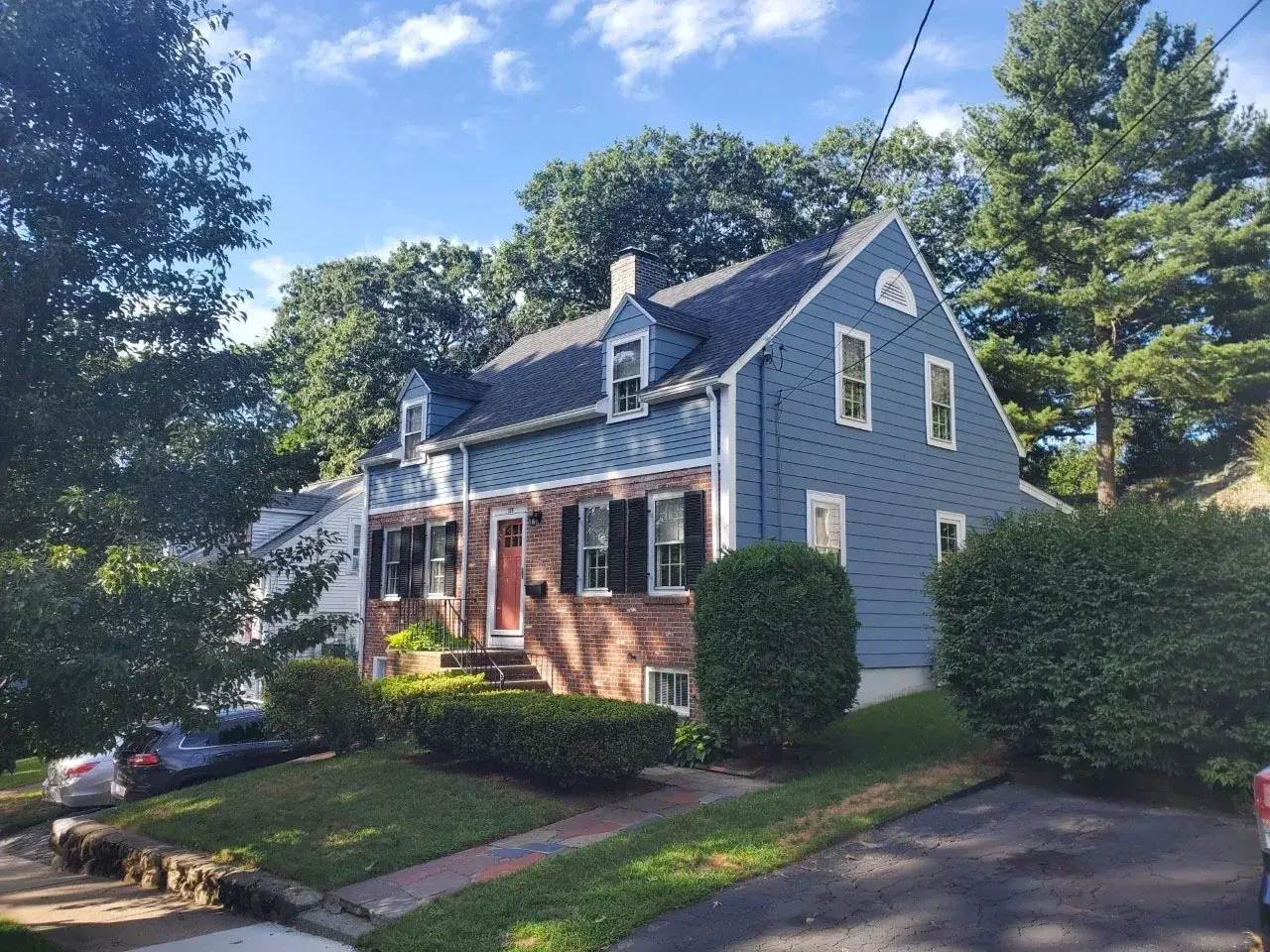 Home addition in Melrose, MA with blue exterior and white trim. Sunroom addition