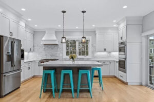 White shaker cabinets with gray island.