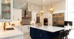 Kitchen with 2 toned cabinets. Island is black and rest of cabinets is white.